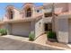 Charming home exterior with a two-car garage, tiled roof, desert landscaping, and covered front porch at 7716 S Rita Ln, Tempe, AZ 85284