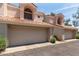 Two-car garage of a lovely two-story home with an arched window and red tile roof at 7716 S Rita Ln, Tempe, AZ 85284