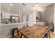 Bright eat-in kitchen features stainless steel appliances, Quartz counters, and a rustic wooden table at 7716 S Rita Ln, Tempe, AZ 85284