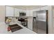 Stylish kitchen with white cabinets, modern stainless appliances, and quartz counters at 7716 S Rita Ln, Tempe, AZ 85284