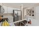 Open kitchen design with stainless steel refrigerator and large sink with bar seating at 7716 S Rita Ln, Tempe, AZ 85284