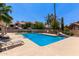 A refreshing community pool area, with clear blue water, lounge chairs and lush landscaping at 7716 S Rita Ln, Tempe, AZ 85284