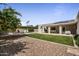 Expansive backyard featuring a covered patio, lush grass, and decorative gravel at 8343 E Quarterhorse Trl, Scottsdale, AZ 85258
