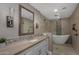 Spa-like bathroom features a soaking tub, tiled walk-in shower, and vanity with modern fixtures at 8343 E Quarterhorse Trl, Scottsdale, AZ 85258