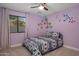 Bright bedroom with fun butterfly decals and a decorative patterned bedspread at 8343 E Quarterhorse Trl, Scottsdale, AZ 85258