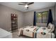 Cozy bedroom with a ceiling fan, natural light, and stylish southwestern-themed bedding at 8343 E Quarterhorse Trl, Scottsdale, AZ 85258