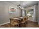 Dining room featuring a modern chandelier, hardwood floors, and views to the exterior at 8343 E Quarterhorse Trl, Scottsdale, AZ 85258