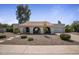 Charming home with desert landscaping, arched entryway, and a tile roof at 8343 E Quarterhorse Trl, Scottsdale, AZ 85258