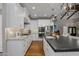 Modern kitchen with stainless steel appliances, white cabinetry, a large island, and stylish pendant lights at 8343 E Quarterhorse Trl, Scottsdale, AZ 85258