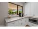 Kitchen featuring white cabinets, stone countertop and a coffee station at 8343 E Quarterhorse Trl, Scottsdale, AZ 85258