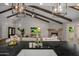 Open concept living space with fireplace and hardwood floors as seen from a kitchen with island at 8343 E Quarterhorse Trl, Scottsdale, AZ 85258