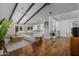 Open concept living room featuring vaulted ceiling, exposed beams, hardwood floors, and modern furnishings at 8343 E Quarterhorse Trl, Scottsdale, AZ 85258