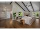 Spacious living room featuring vaulted ceilings, exposed beams, and a cozy fireplace at 8343 E Quarterhorse Trl, Scottsdale, AZ 85258