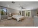 Spacious main bedroom with neutral tones, ceiling fan, and french doors to the exterior at 8343 E Quarterhorse Trl, Scottsdale, AZ 85258