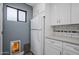 Mudroom area features white cabinets, countertops and a convenient doggie door at 8343 E Quarterhorse Trl, Scottsdale, AZ 85258
