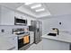 Modern kitchen featuring white cabinets, stainless steel appliances, and ample counter space at 848 E Morningside Dr, Phoenix, AZ 85022