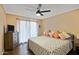 Cozy bedroom with a ceiling fan, a queen-sized bed, a TV, and a sliding glass door to the exterior at 848 E Morningside Dr, Phoenix, AZ 85022