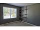 Cozy bedroom with natural light and wall-mounted shelving for added storage at 10232 N 86Th St, Scottsdale, AZ 85258