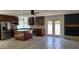 An open kitchen with a center island, stainless steel appliances, and a connected fireplace at 10232 N 86Th St, Scottsdale, AZ 85258
