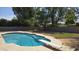 An inviting backyard pool with a diving board and mature trees at 10232 N 86Th St, Scottsdale, AZ 85258