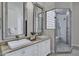 An elegant bathroom boasts double sinks, granite countertops, and a glass-enclosed shower at 10310 N 135Th Way, Scottsdale, AZ 85259