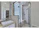 Modern bathroom featuring glass-enclosed shower, granite countertop, and walk-in closet access at 10310 N 135Th Way, Scottsdale, AZ 85259