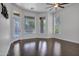 Bright bedroom with hardwood floors, large windows, and pool view at 10310 N 135Th Way, Scottsdale, AZ 85259