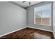 Neutral bedroom with hardwood floors, a ceiling fan, and a sunlit window at 10310 N 135Th Way, Scottsdale, AZ 85259