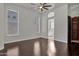 A spacious bedroom boasts hardwood floors, two large windows, and a ceiling fan at 10310 N 135Th Way, Scottsdale, AZ 85259