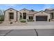 Charming single-story home featuring stucco exterior, desert landscaping, and a two-car garage at 10310 N 135Th Way, Scottsdale, AZ 85259