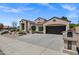 Attractive home features desert landscaping, a two-car garage, and a private mailbox at 10310 N 135Th Way, Scottsdale, AZ 85259