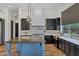 Gourmet kitchen with custom island, dark cabinets, light countertops and tile backsplash at 10310 N 135Th Way, Scottsdale, AZ 85259
