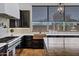 Close-up of kitchen featuring modern appliances, custom cabinetry, and a view to the backyard at 10310 N 135Th Way, Scottsdale, AZ 85259