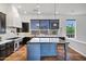 Spacious kitchen features a large island, professional-grade appliances, and stylish dark wood cabinetry at 10310 N 135Th Way, Scottsdale, AZ 85259