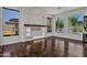 Living room with decorative built-ins and large windows with views of pool and landscaped backyard at 10310 N 135Th Way, Scottsdale, AZ 85259