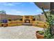 Charming outdoor fireplace with a stone surround and built-in seating, perfect for relaxing evenings at 10310 N 135Th Way, Scottsdale, AZ 85259