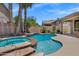 Inviting pool and spa area surrounded by palm trees and lush landscaping at 10310 N 135Th Way, Scottsdale, AZ 85259