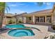 Beautiful pool and spa create a backyard oasis with palm trees and greenery at 10310 N 135Th Way, Scottsdale, AZ 85259