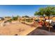 The backyard features raised garden beds, playful decor, and space for entertaining, all under the open sky at 10618 W Prairie Ln, Casa Grande, AZ 85193