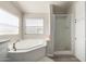 Corner soaking tub and walk-in shower in a light-filled bathroom at 10618 W Prairie Ln, Casa Grande, AZ 85193