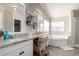 Bright bathroom with dual vanity, soaking tub, and neutral color scheme at 10618 W Prairie Ln, Casa Grande, AZ 85193