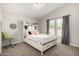 Bright bedroom with white bed frame, gray curtains, and dart board decor at 10618 W Prairie Ln, Casa Grande, AZ 85193