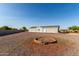 Spacious lot with a charming single-story home, gravel landscaping, and brick firepit, ideal for outdoor enjoyment at 10618 W Prairie Ln, Casa Grande, AZ 85193