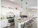 Open kitchen with stainless steel appliances, granite countertops, and breakfast bar seating at 10618 W Prairie Ln, Casa Grande, AZ 85193