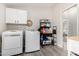 Bright laundry room with modern appliances and storage, with easy access to the rest of the home at 10618 W Prairie Ln, Casa Grande, AZ 85193