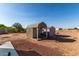 Outbuildings include two storage units and a well manicured yard for play and utility at 10618 W Prairie Ln, Casa Grande, AZ 85193