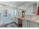 Luxurious bathroom featuring double sinks, tiled shower, and contemporary finishes at 12042 S 44Th St, Phoenix, AZ 85044