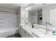 Bright bathroom featuring dual sinks and a shower-tub combo, providing a clean and modern design at 12042 S 44Th St, Phoenix, AZ 85044