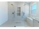 Bright bathroom features dual shower heads and a built-in tiled niche for storage at 12042 S 44Th St, Phoenix, AZ 85044