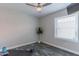 This room has modern flooring, a ceiling fan, and a window looking out onto the neighborhood at 12042 S 44Th St, Phoenix, AZ 85044